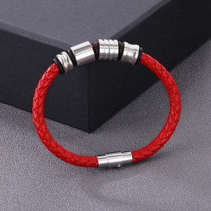 Close-up of red braided leather bracelet with silver metal rings and magnetic clasp