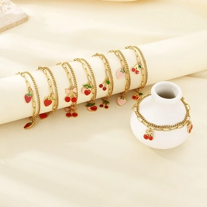 Double-layered 18K gold plated stainless steel anklet with red enamel strawberry charms