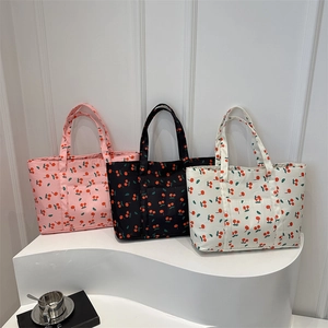 Minimalist cherry print tote bag in pink, black, and beige colors on a white display