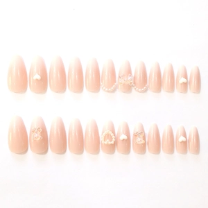Pink gradient almond press-on nails with 3D bears, pearls, and heart decorations
