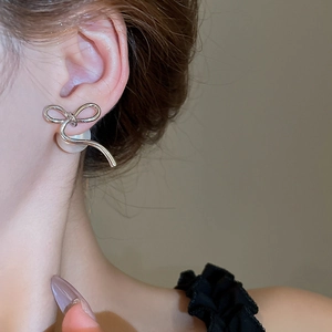 Elegant 14K gold plated bowknot pearl earrings shown on model for a French chic look