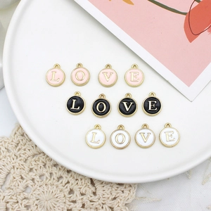 Alphabet charms set with LOVE letters in pink black and white enamel with gold trim