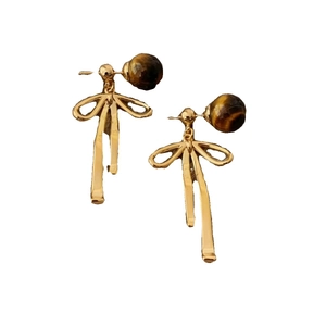 Golden bow earrings with brown tiger eye stone beads on a clean white background