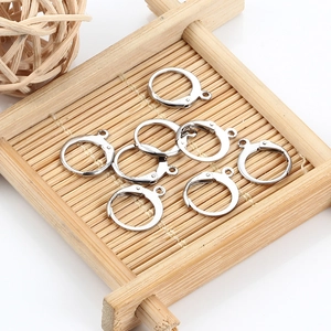 Eight silver stainless steel earring hooks on a woven tray for DIY jewelry making