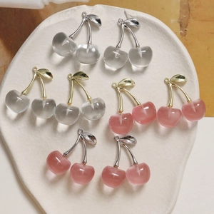 Detailed view of translucent cherry pendants in pink and grey with metallic leaves