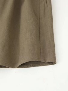 Detail of army green embroidered blouse featuring rustic linen texture and premium stitching