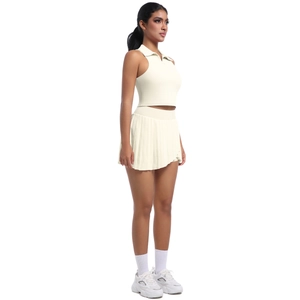 Détail de la jupe de sport plissée et du gilet polo sans manches de couleur blanc crème