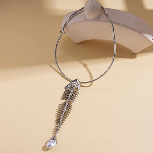 Detailed view of silver fishbone pendant with pearl on a rigid choker necklace