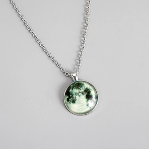 Macro detail of lunar pendant showing realistic moon surface texture on a silver chain