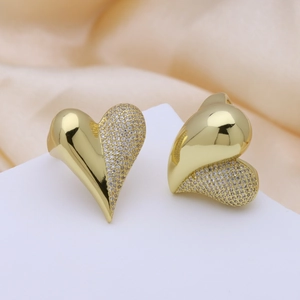 Elegant gold heart earrings with zircon micro-paving on a premium silk background