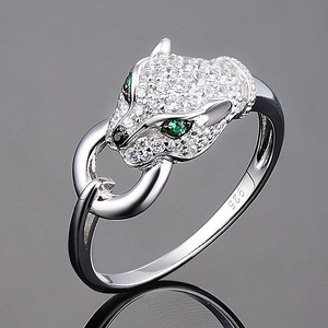 Macro shot of silver panther ring with green stone eyes and 925 sterling silver stamp