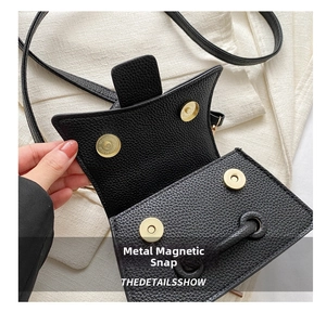 Detail of black lychee grain leather interior with four gold magnetic snap closures