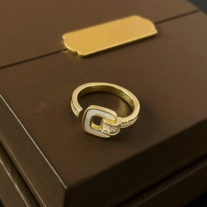 Macro detail of gold lock-shaped ring with mother of pearl inlay and sparkling zircon stones