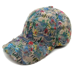 Close-up of floral distressed denim baseball cap with BEAUTIFUL embroidery and frayed holes