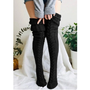 Close-up of black cable-knit over-the-knee socks showing detailed thick wool texture