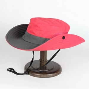 Detail of red sun hat featuring a breathable side mesh and adjustable black chin strap