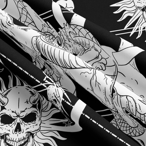Detailed close-up of gothic mountain tapestry fabric with black and white skull patterns