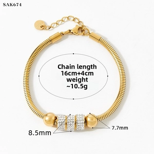 Detail of gold snake chain bracelet with diamond-set beads and length measurements