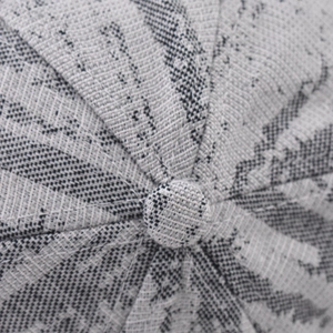 Macro detail of thick plaid baseball cap showing premium woven grey fabric and top button