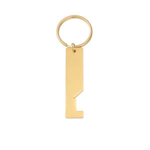 Macro shot of gold stainless steel bottle opener keychain with a sleek polished finish