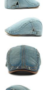 Detail of washed denim beret featuring orange contrast stitching and adjustable metal buckle