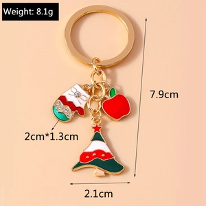 Detailed Christmas keychain with red apple, festive tree, and rhinestone glove charm