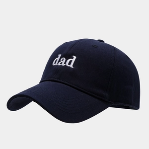 Detail of white dad embroidery on navy blue cotton six-panel baseball cap