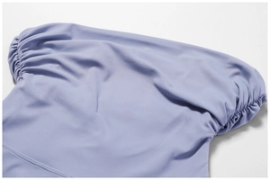 Detailed view of elastic shirring texture on high waist light purple yoga flared pants