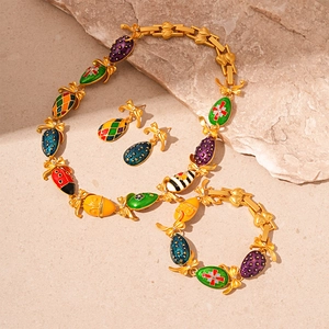 Vintage gold jewelry set with colorful enamel butterfly and insect charms on stone