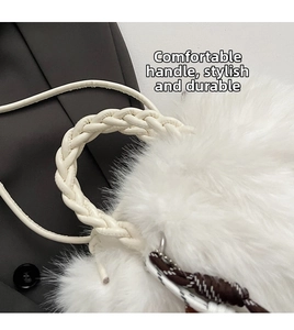 Detail of soft white faux fur bag with woven leather handle and textured shoulder strap