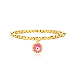 Detail of gold beaded bracelet featuring a pink enamel evil eye charm with gear edge