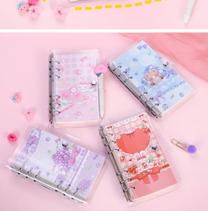 Detailed view of mini transparent loose-leaf binders with cute cartoon fruit and bear patterns
