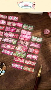 Detailed view of vintage style cat and dessert stickers for creative DIY journal scrapbooking