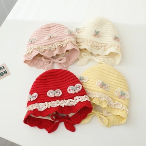Detailed knit texture and delicate lace edges on colorful winter baby beanies set