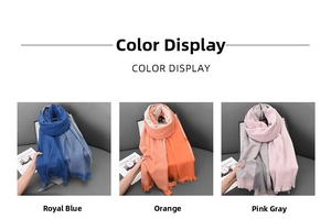 Close-up of royal blue, orange, and pink grey cashmere-like scarves with fringe details