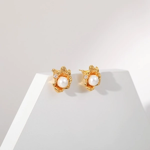 Irregular geometric flower pearl earrings with gold plating and zircon accents on white stand