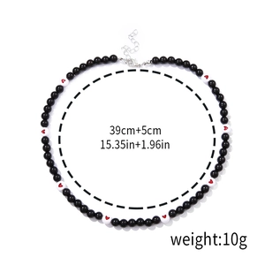 Detail of beaded necklace with red heart and measurements 39cm plus 5cm extension