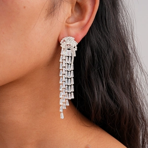 Silver jellyfish tassel earrings with zircon crystals on a model shown from a side view