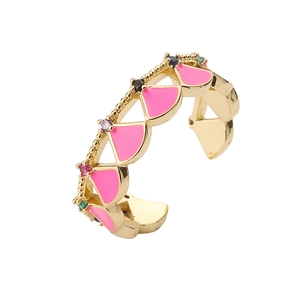 Golden seashell inspired open ring with pink enamel and colorful crystals on white background