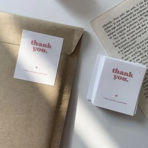 Minimalist white 'Thank You' cards with pink text and envelopes for gift packaging