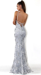 Silver sequin dress back view showing intricate lace-up details and deep open back style