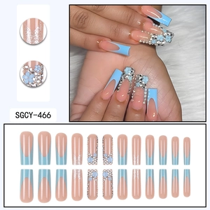 Sky blue press-on nails with 3D flowers, pearls, and glitter in long ballerina shape