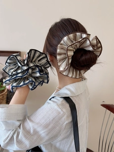 Detail of fabric striped scrunchies showing textured ruffled layers for hair styling