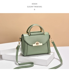 Detail of matcha green handbag featuring a gold twist lock and woven side textures