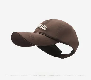 Detail view of brown embroidered Colorado sun visor hat with open top for ponytails