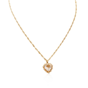 Close-up of heart pendant necklace in gold finish with sparkling zircon stones