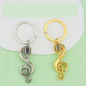 Music themed keychains featuring gold and silver treble clef with microphone charms