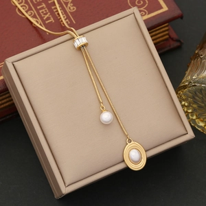 Golden Y-shaped stainless steel necklace with pearl tassels and rectangular crystal slide