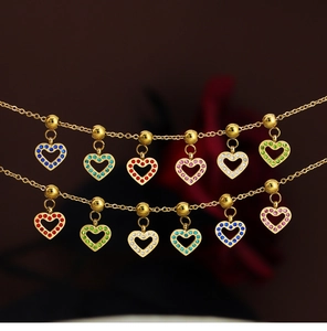 Macro shot of gold-plated hollow heart pendants with colorful inlaid rhinestones