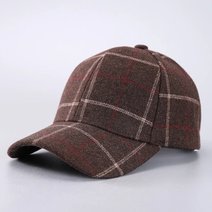 Close-up of brown houndstooth wool fabric texture on a retro winter baseball cap